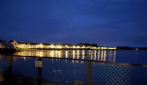 Twinkling lights of Garlieston across its bay